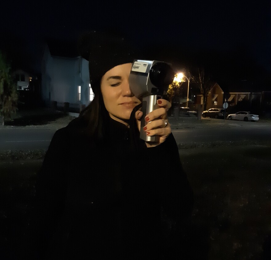 Alison Flowers, director of investigations for the Chicago-based Invisible Institute, is shown using a light meter Nov. 18, 2021, at the spot where, under similar lighting conditions, Cortez Bufford was killed about two years prior.