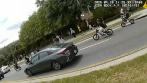 Students leave Windermere High School on e-bikes, weaving through traffic.