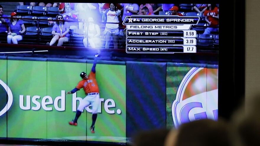 Reporters and Major League Baseball employees watch a demonstration of new statistics made possible by technology upgrades at baseball stadiums during an April 20 news conference in New York.