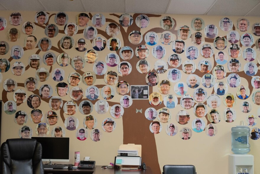 A wall in the New Beginnings clinic shows many of the coal miners who've been treated there. Respiratory therapist Marcy Freeman also has a collection of funeral programs for those who've died.