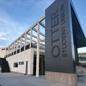 Outside view of a building with Otter Student Union in large letters on the face of it.