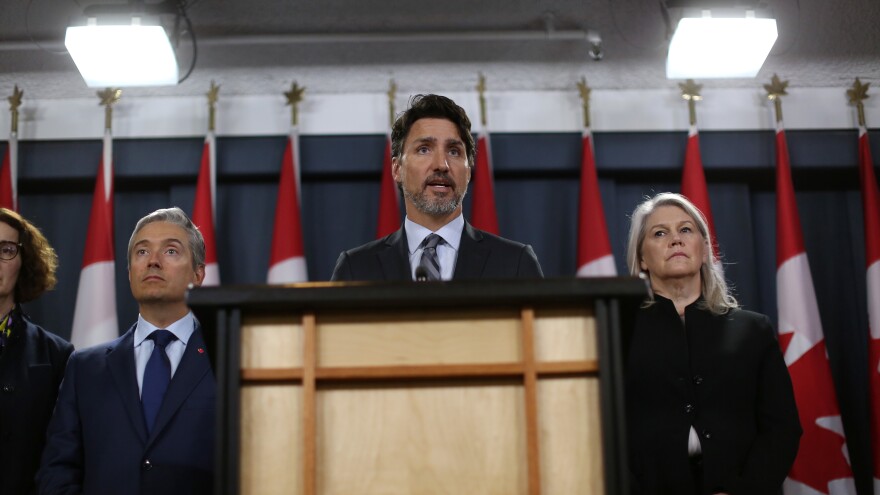 Canadian Prime Minister Justin Trudeau addresses a news conference Saturday in Ottawa, flanked by high-level ministers. Trudeau called the Iranian admission a "step forward," but noted there are lots of questions still to be answered.