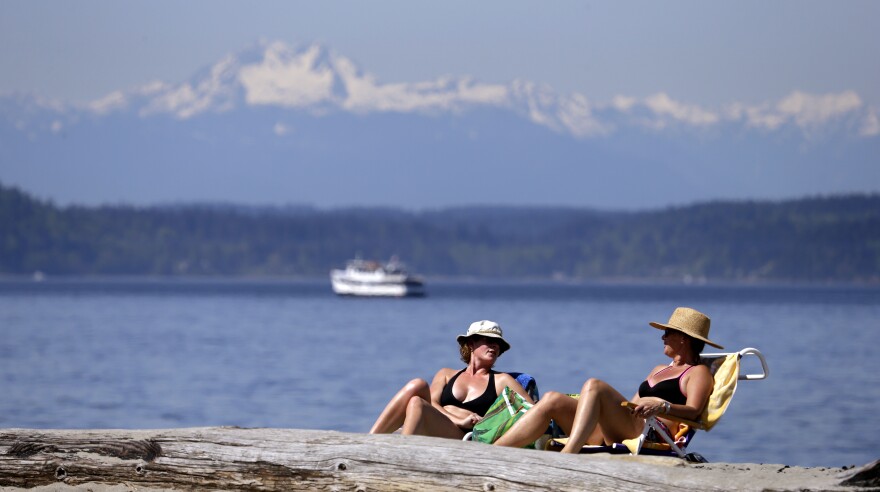 Beach-goers in Seattle enjoy a Puget Sound shore in Seattle. 