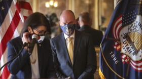 A photo of Spencer Cox and Deidre Henderson at the gov transition announcement. 