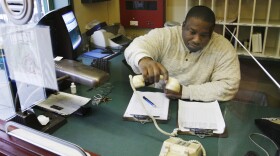 Johnnie Lee Savory answers the phone at the residential facility where he lives and works in Chicago on Friday, Nov. 16, 2007.