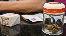  An employee at Fresh Green dispensary checks out a customer purchasing a variety of different recreational cannabis products