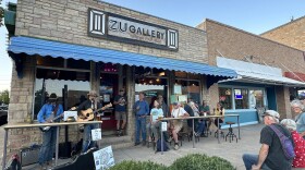 Local band High Desert Strays performs outside ZU Gallery in downtown Cortez during Music on the Porch Day, as community members gather along Main Street for the live event.