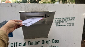 An Oregon voter makes use of one of many official ballot drop boxes across Lane County.