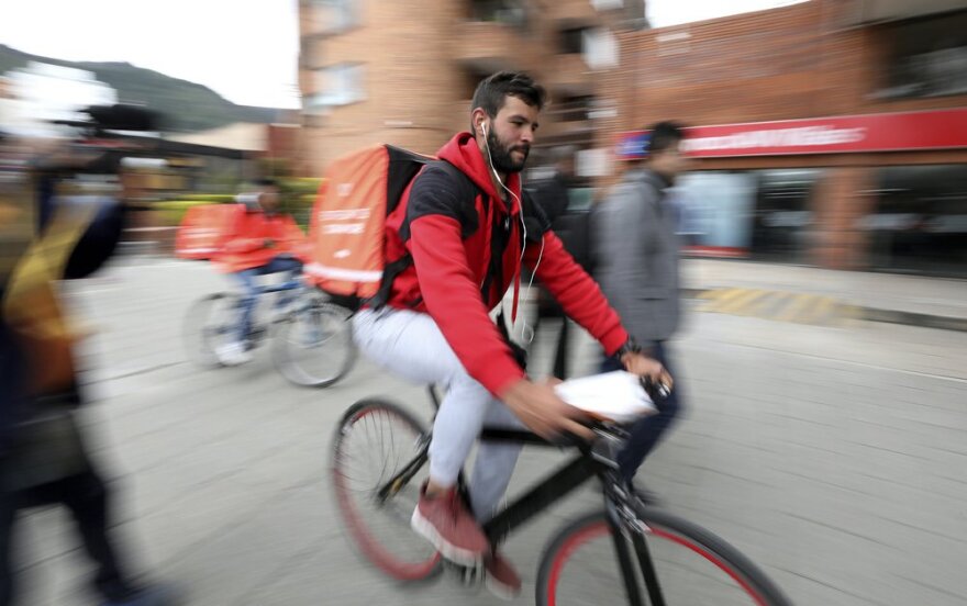 A delivery courier for Colombian startup Rappi moves through Bogota.