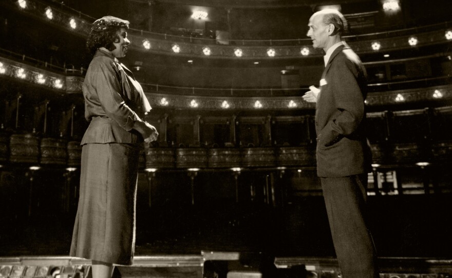 Rudolf Bing of the Metropolitan Opera (right) stands with Marian Anderson on Oct. 7, 1954. Bing invited Anderson to perform the role of Ulrica in Giuseppe Verdi's <em>A Masked Ball</em> in January 1955. Anderson was the first African-American to sing a role in a Met production.