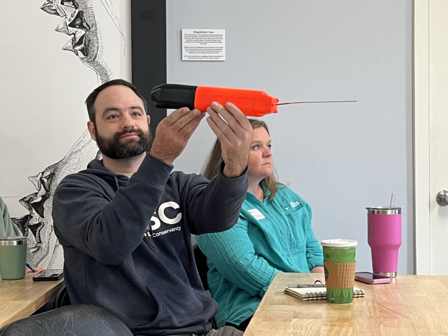 Patrick Rex, a research scientist at the Atlantic White Shark Conservancy, holds a camera tag capable of capturing video of a "shark's-eye view" of the animal's movement when attached to the fin of a white shark.