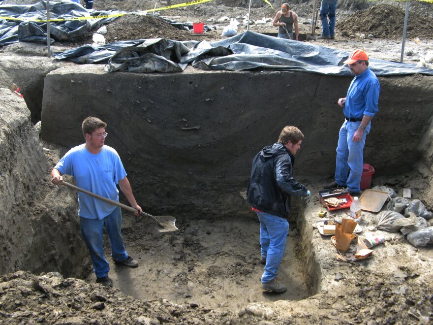 Research coordinator Joe Galloy looks on as crew members excavate a large storage pit at the dig site. Archaeologists are not sure of its original function, but the Cahokians may have used it to store corn or other food. Later on, they threw their trash into it, including the bones of deer and fish, and pieces of broken clay pots and bowls.