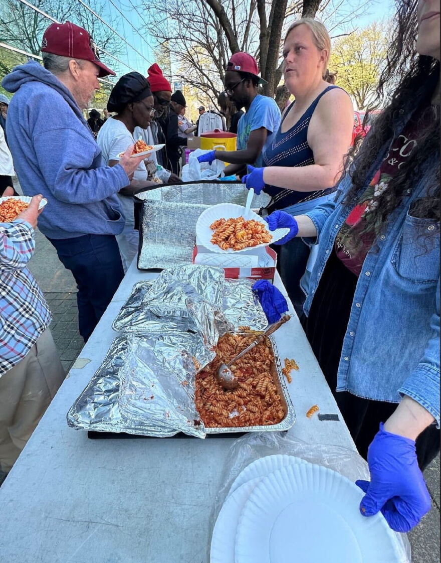 Organization, Food Not Bombs Midlands, distributing food to unhoused persons outside of the Richland Library Main.