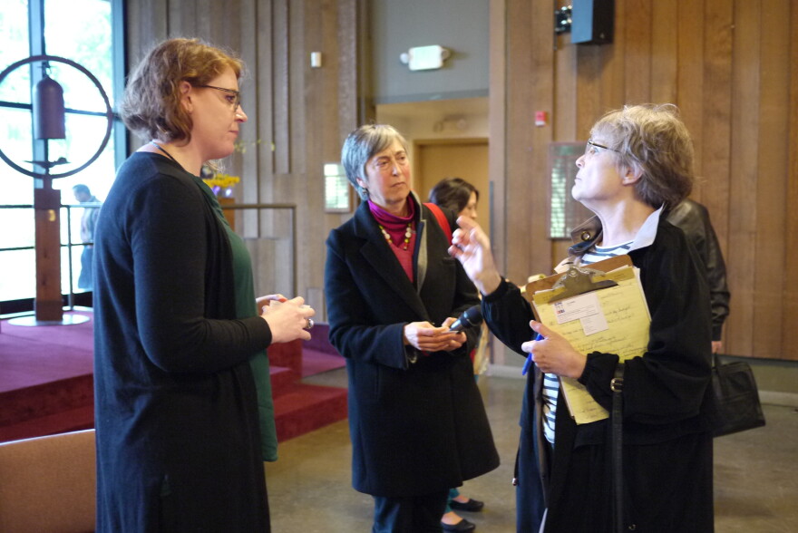 ICE community relations officer Melissa Nitsch (left) talks with community members