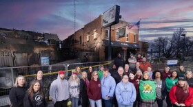 Staff in front of the fire damaged Curve Inn bar.