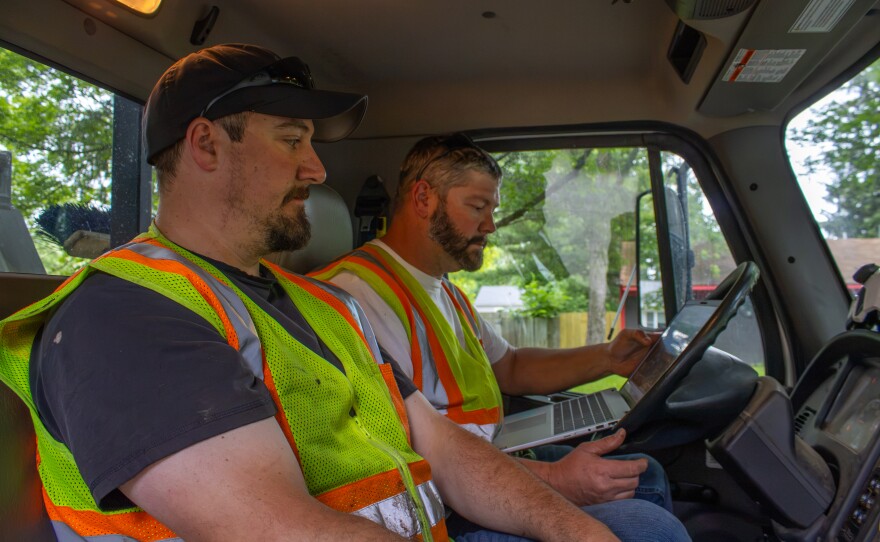 Leonard Nicolai and Matthew Nagle, two of five aborists employed by the city of Midland, consult an electronic work order database as they prepare to move on to the next area of tree-service needs on Thursday, June 18, 2026.
