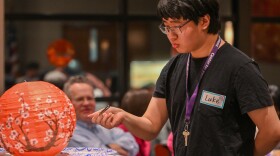 A student at the University of Scranton participates in a chopstick competition during the university's Lunar New Year celebration.