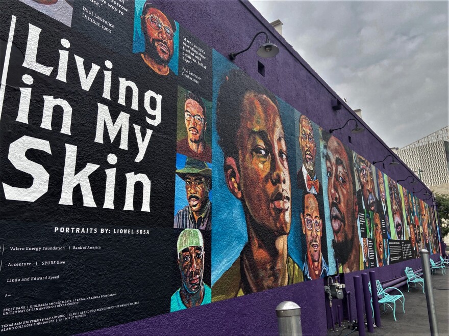 The mural with the Tobin Center in the backdrop