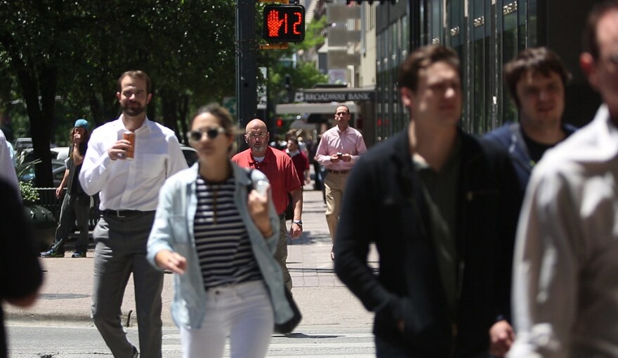 Pedestrians cross the street in downtown Austin. 