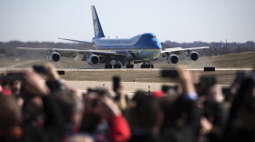 Onlookers watch as Air Force One lands at St. Louis Lambert International Airport in March 2018.