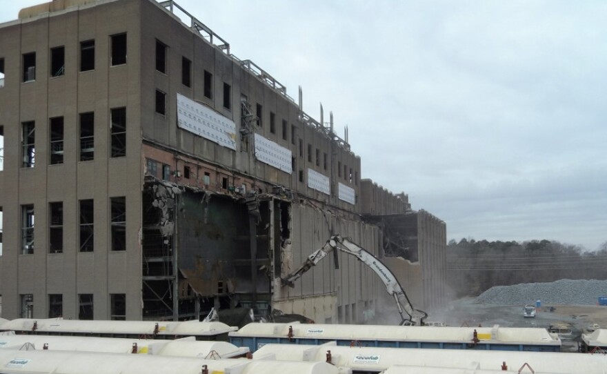 Workers are tearing down the back wall of the plant. 