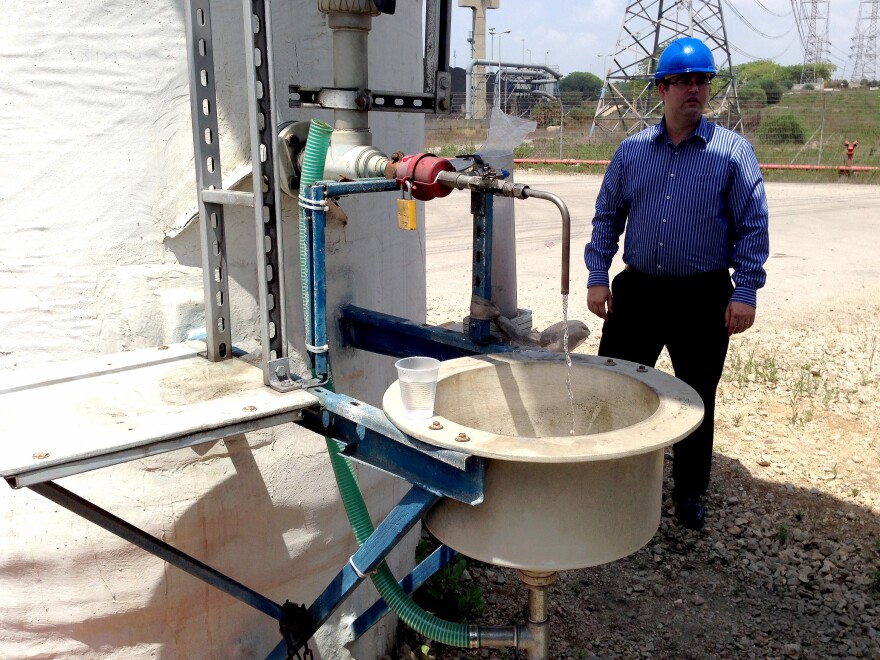 Tomer Efrat, a manager at IDE Technologies, stands near a tasting faucet at the Hadera desalination plant.