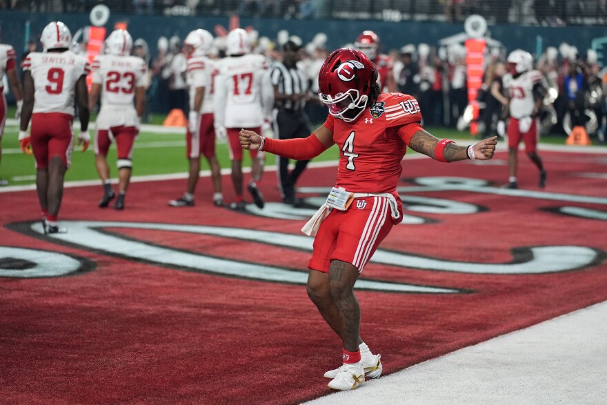 Utah quarterback Devon Dampier (4) celebrates after scoring a touchdown against Nebraska during the first half of the Las Vegas Bowl NCAA college football game Wednesday, Dec. 31, 2025, in Las Vegas.