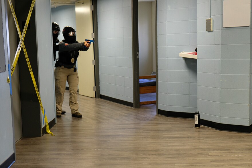 A police officer tells a role-playing trainer to drop his weapon in Roskey Hall Dormitory at MSU's Campus in Bozeman, Montana, August 08, 2019.