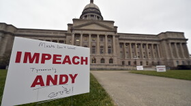 Signs, some with personal messages promoting the impeachment of Kentucky Governor Andy Beshear line the walkway and lawn of the State Capitol building in Frankfort, Ky., Tuesday, Jan. 5, 2021.