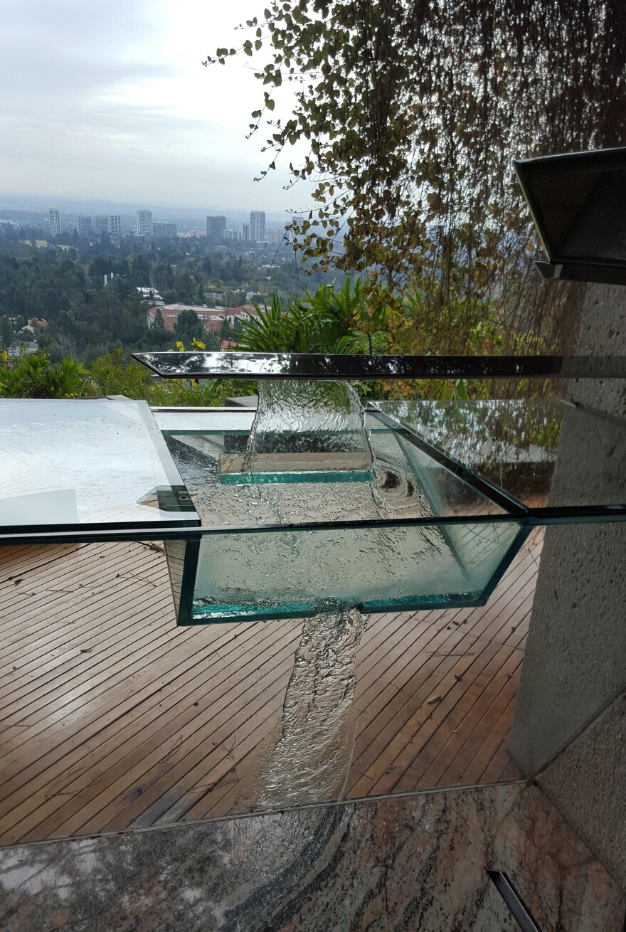 Goldstein's master bathroom features a glass sink with no faucets. A hidden spout offers water with the wave of a hand and drains outside the window.