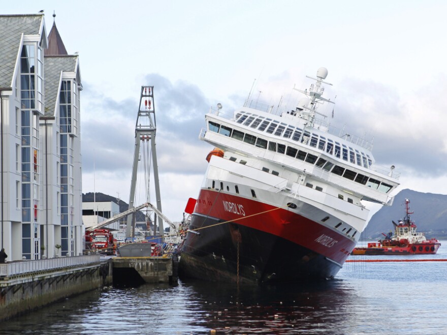 The MS Nordlys sits stricken in the water at Aalesund in western Norway.