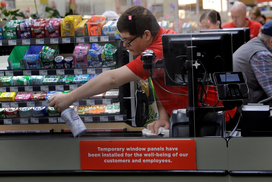 grovecy store worker cleaning checkout counter