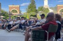 People sitting in camping chairs in plaza