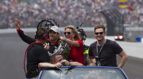Will Power waves to the crowd with his wife, Elizabeth, during the victory lap after winning the Indianapolis 500 on Sunday.