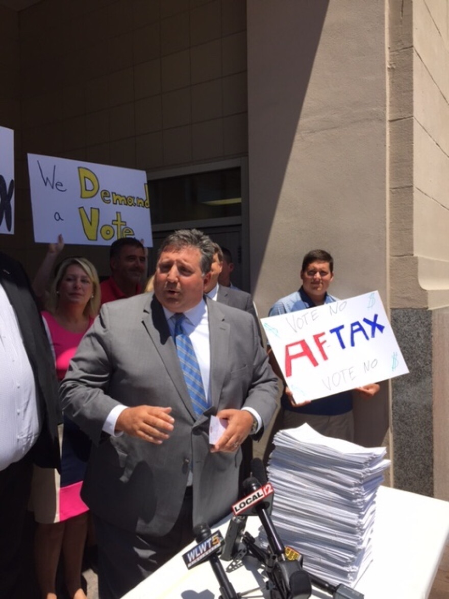 Hamilton County Republican Party Chairman Alex Triantafilou with sales tax repeal petitions. Behind him are GOP volunteers urging people to vote down the "Aftax," a reference to Democratic Clerk of Courts Aftab Pureval. 