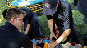 Cameron Loureiro, left, puts spider straps on a dummy patient who has lost limbs during an emergency call scenario.