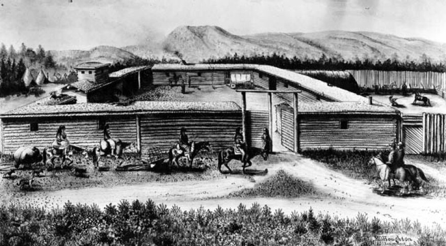 A black and white image of Fort Bridger with men riding horses in front of its walls