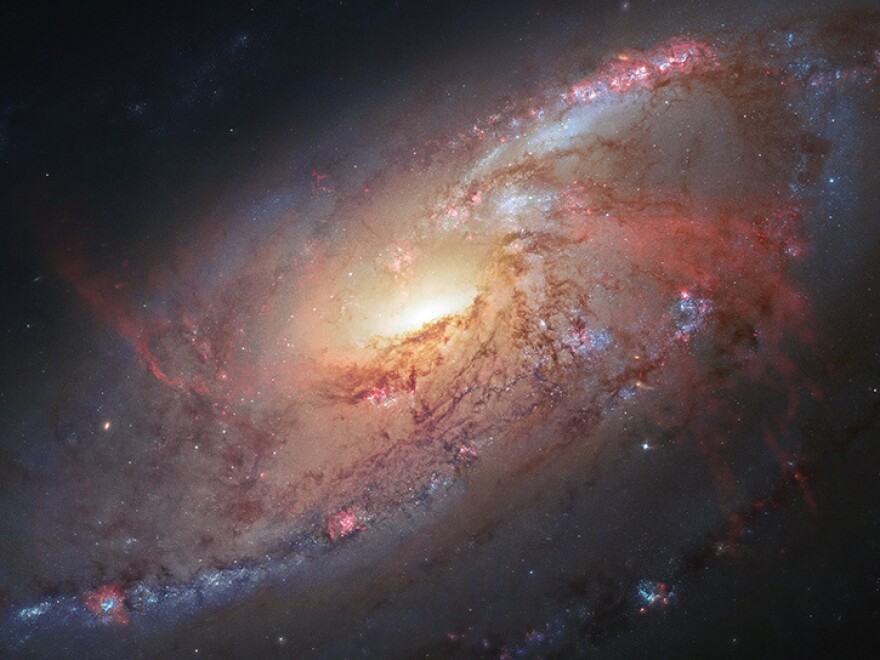 The inner structure of galaxy M106 (23.5 million light-years away) as seen by combining Hubble data with images taken by photographers.