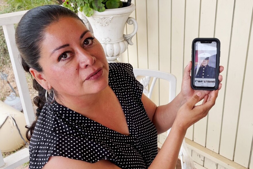 Norma Apodaca holds a photo of her brother, former Marine Erasmo Apodaca. Apodaca was deported after he left the service and died before he could have his deportation case reviewed.