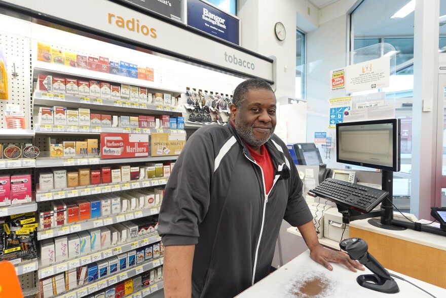 Seon Browne stands in front of his cashier station in Portland on June 29, 2025.
