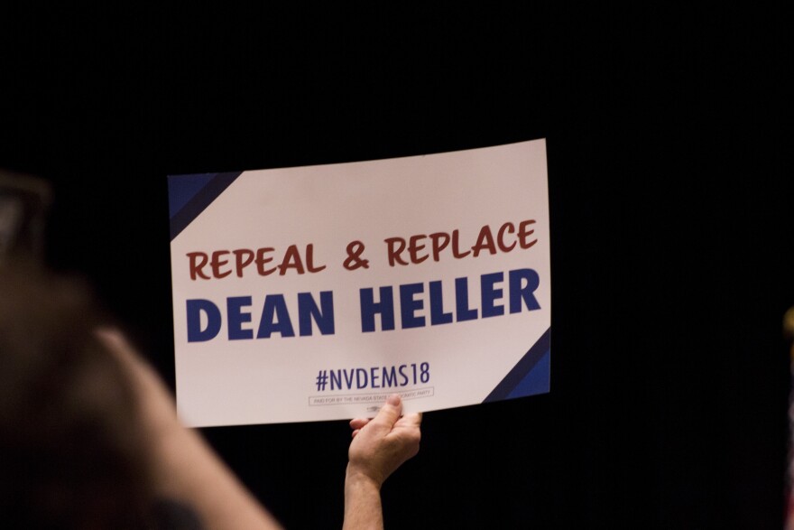 Someone holds up an anti-Dean Heller sign