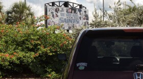A University of Florida sticker is seen on a car parked near a Santa Fe College sign in Gainesville.
