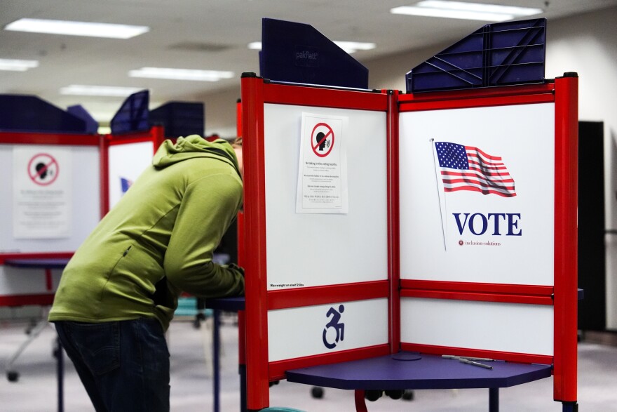 FILE - A person votes early in the Virginia redistricting referendum at the Fairfax County Government Center, April 3, 2026, in Fairfax, Va.
