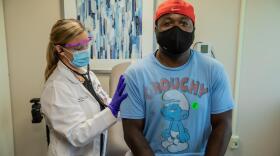 Patient Jarelle Marshall recieves the first dose in UC Moderna trial in August.