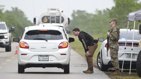 Police check cars arriving at the "Alligator Alcatraz," a new migrant detention facility at the Dade-Collier Training and Transition facility, Wednesday, July 2, 2025, in Ochopee, Fla.