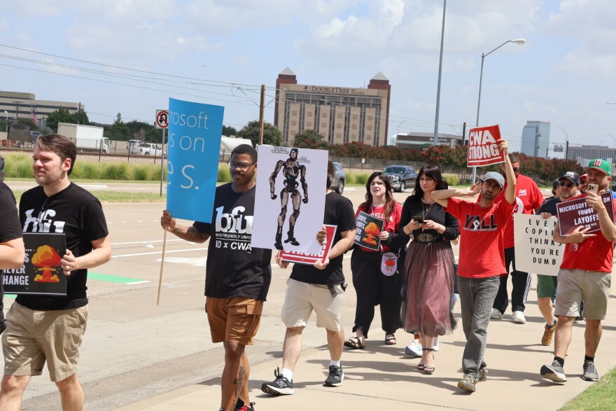 Workers march with signs outside the id Software office building in Richardson on July 15, 2026 to protest Xbox layoffs that eliminated 1,600 roles effective immediately in early July. 