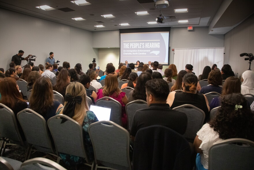Crowd of people in room looking at screen