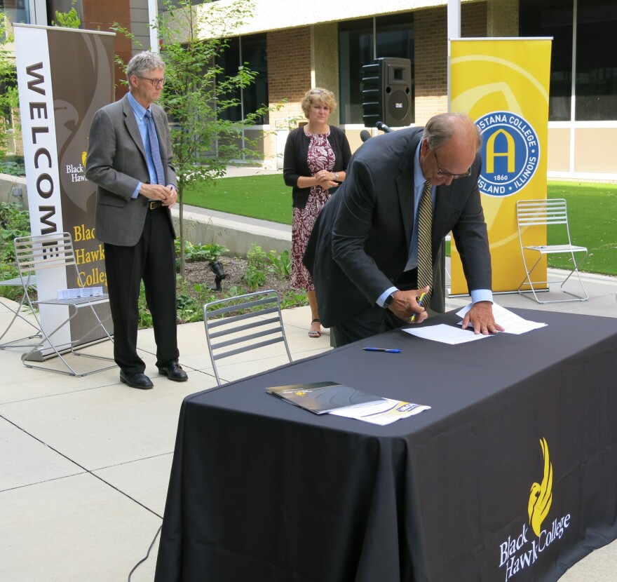 Augustana College President Steve Bahls signing the agreement, with BHC President Tim Wynes and Vice President for Instruction Dr. Amy Maxeiner.