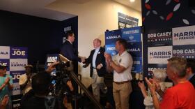 U.S. Sen. Chris Coons (D-Del.), center, shakes hands with state Rep. Kyle Mullins, (D-Blakely) during a Harris-Walz campaign rally Monday in Dunmore.