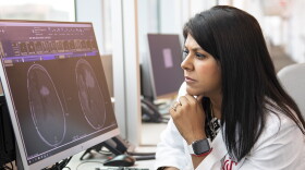 Dr. Rekha Chaudhary looks at brain scans at the University of Cincinnati.